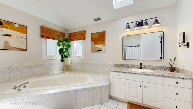 1531 Walnut St, Western Springs, IL 60558 - full bathroom with vanity, a garden tub, vaulted ceiling, tile patterned flooring, and a skylight