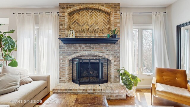 1531 Walnut St, Western Springs, IL 60558 - living area with wood finished floors, a brick fireplace, plenty of natural light, and baseboards
