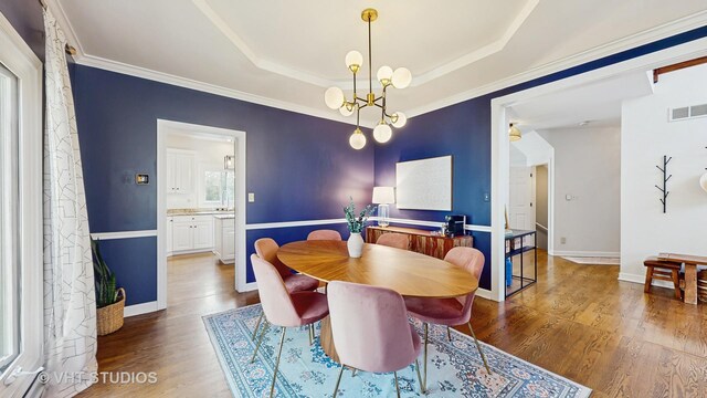 1531 Walnut St, Western Springs, IL 60558 - dining space featuring wood finished floors, a tray ceiling, ornamental molding, baseboards, and a chandelier