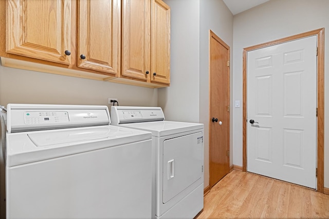 1496 Trailwood Dr, Crystal Lake, IL 60014 - laundry room featuring cabinet space, light wood-style floors, washing machine and dryer, and baseboards