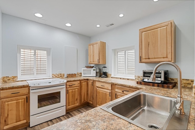 1496 Trailwood Dr, Crystal Lake, IL 60014 - kitchen featuring white appliances, a sink, light wood-style flooring, light countertops, and recessed lighting