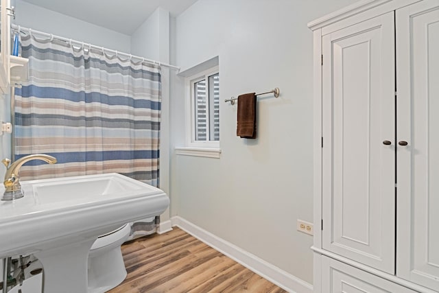 1496 Trailwood Dr, Crystal Lake, IL 60014 - full bath featuring wood finished floors, baseboards, a shower with shower curtain, and a sink