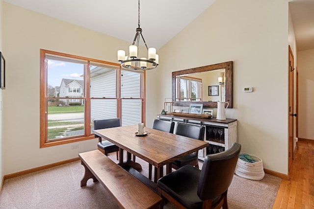 1496 Trailwood Dr, Crystal Lake, IL 60014 - dining space featuring a chandelier, baseboards, healthy amount of natural light, light wood-type flooring, and high vaulted ceiling