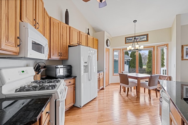 1496 Trailwood Dr, Crystal Lake, IL 60014 - kitchen with white appliances, a chandelier, light wood-style floors, dark stone countertops, and decorative light fixtures