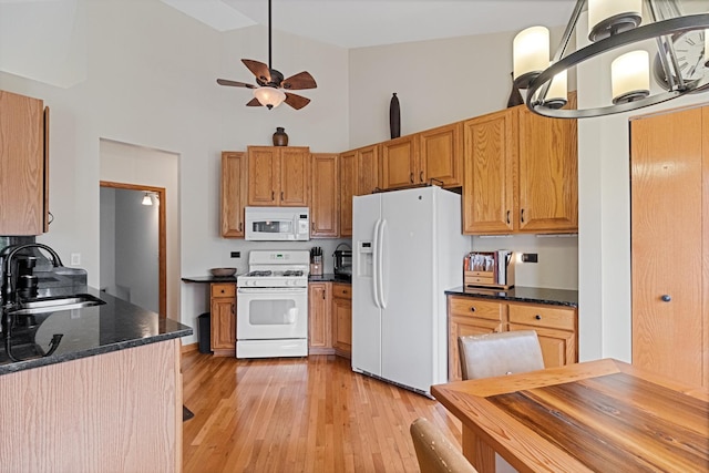 1496 Trailwood Dr, Crystal Lake, IL 60014 - kitchen featuring white appliances, a sink, a towering ceiling, light wood-style floors, and a ceiling fan