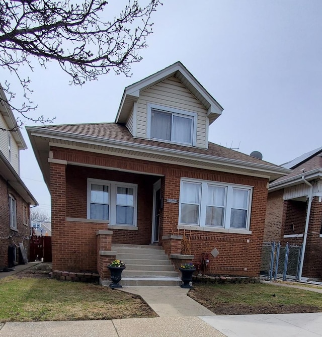 4627 W Schubert Ave, Chicago, IL 60639 - bungalow with brick siding, fence, and roof with shingles