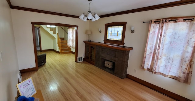 4627 W Schubert Ave, Chicago, IL 60639 - living area featuring stairs, a notable chandelier, crown molding, light wood-style flooring, and baseboards