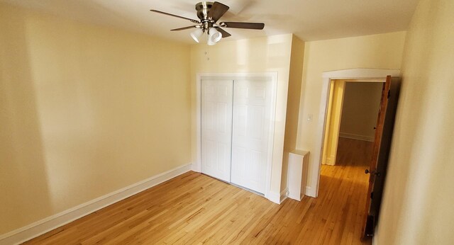 4627 W Schubert Ave, Chicago, IL 60639 - unfurnished bedroom with baseboards, light wood-type flooring, and a ceiling fan