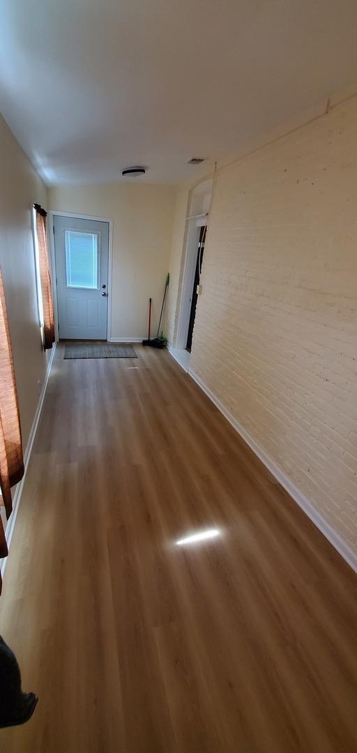 4627 W Schubert Ave, Chicago, IL 60639 - interior space with baseboards and wood finished floors