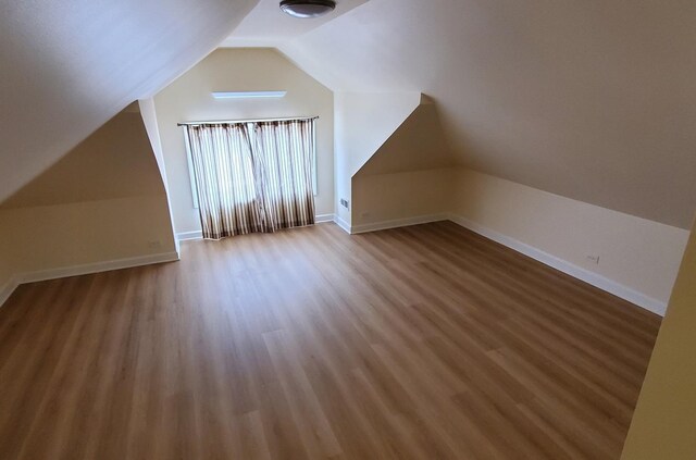 4627 W Schubert Ave, Chicago, IL 60639 - bonus room with baseboards, lofted ceiling, and wood finished floors
