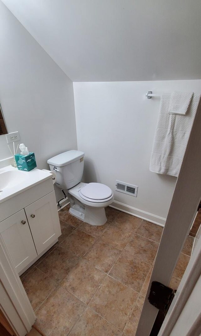4627 W Schubert Ave, Chicago, IL 60639 - bathroom featuring baseboards, visible vents, toilet, and vanity