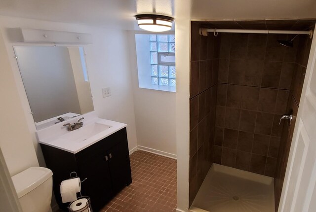 4627 W Schubert Ave, Chicago, IL 60639 - bathroom featuring baseboards, toilet, a stall shower, and vanity