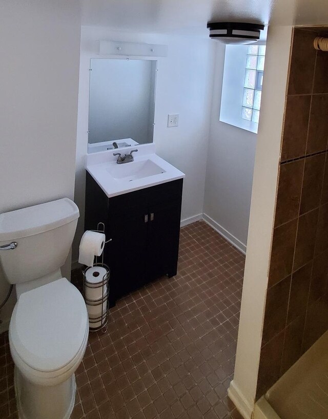 4627 W Schubert Ave, Chicago, IL 60639 - bathroom featuring baseboards, toilet, and vanity