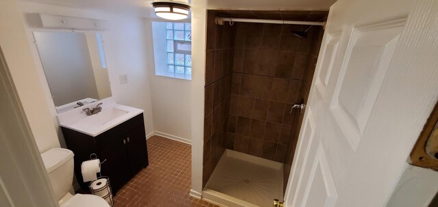 4627 W Schubert Ave, Chicago, IL 60639 - bathroom with toilet, vanity, a stall shower, and baseboards