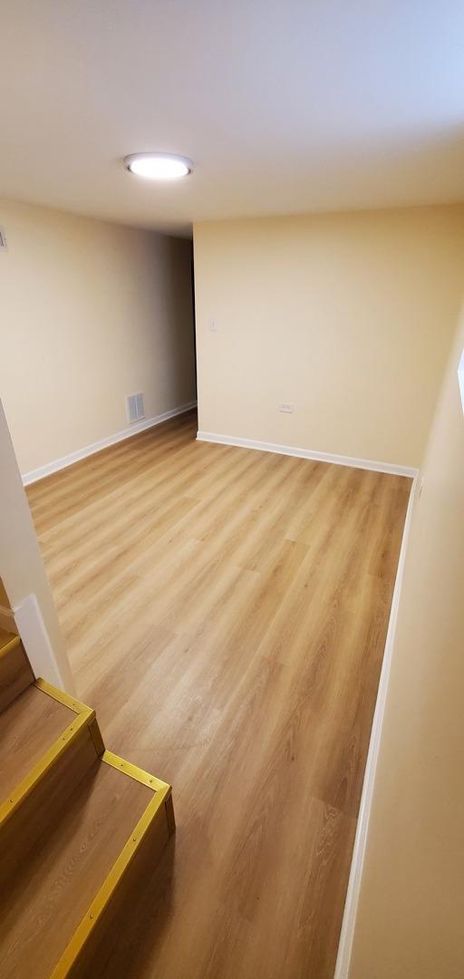 4627 W Schubert Ave, Chicago, IL 60639 - interior space featuring baseboards, visible vents, light wood-style flooring, and stairs
