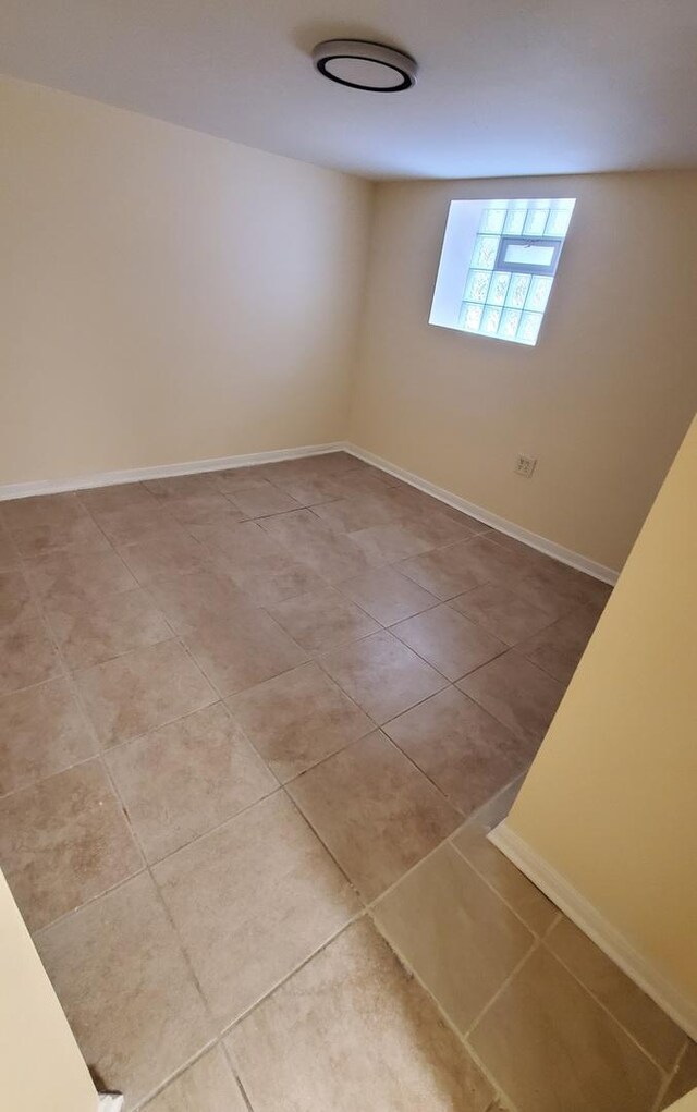 4627 W Schubert Ave, Chicago, IL 60639 - tiled empty room featuring baseboards
