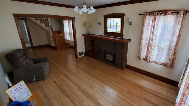 4627 W Schubert Ave, Chicago, IL 60639 - living room with visible vents, a notable chandelier, baseboards, and wood finished floors