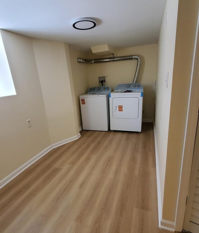 4627 W Schubert Ave, Chicago, IL 60639 - washroom with light wood finished floors, baseboards, separate washer and dryer, and laundry area