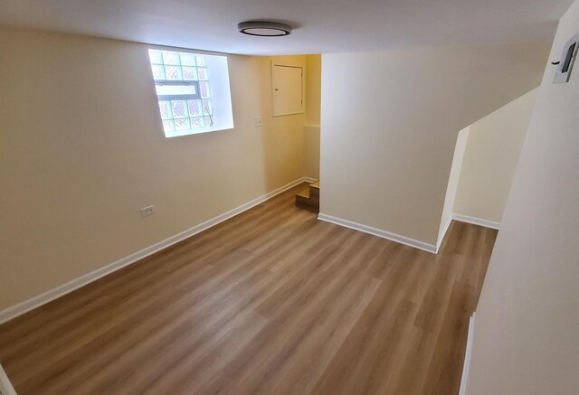 4627 W Schubert Ave, Chicago, IL 60639 - below grade area with electric panel, baseboards, and wood finished floors