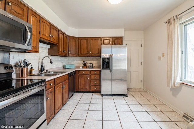 3645 Elm Ct, Flossmoor, IL 60422 - kitchen with tasteful backsplash, light countertops, brown cabinets, appliances with stainless steel finishes, and a sink