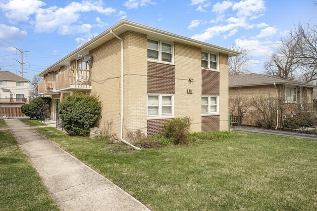 119 N Cliff St, Willow Springs, IL 60480 - view of home's exterior with brick siding, a yard, and a balcony