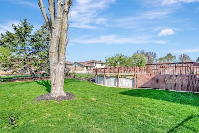 view of yard with a fenced in pool and fence