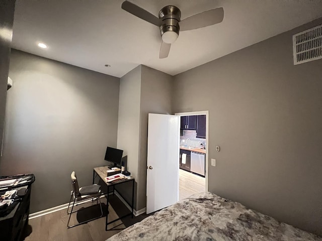 bedroom with visible vents, wood finished floors, and a ceiling fan