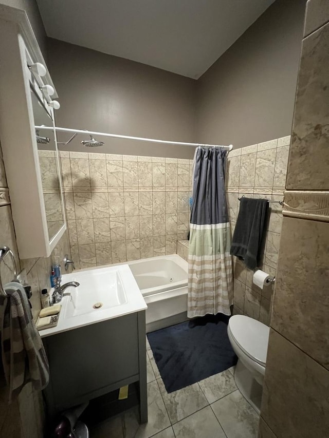 full bathroom with shower / bathtub combination with curtain, vanity, tile walls, toilet, and marble finish floor