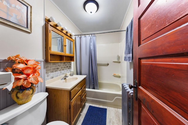 full bathroom featuring shower / bath combo, vanity, toilet, and radiator