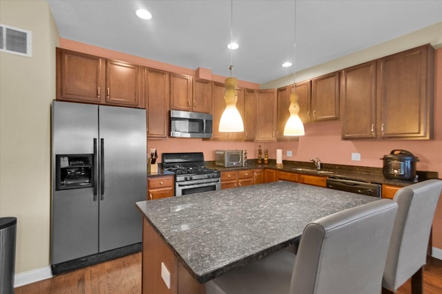 6510 S Woodlawn Ave Unit 1, Chicago, IL 60637 - kitchen with a sink, wood finished floors, stainless steel appliances, visible vents, and recessed lighting