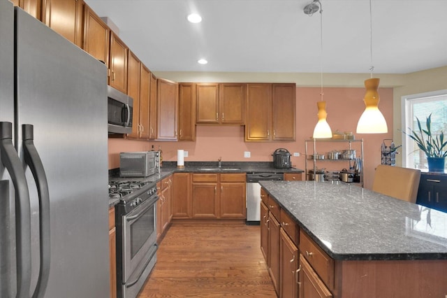 6510 S Woodlawn Ave Unit 1, Chicago, IL 60637 - kitchen with a sink, wood finished floors, dark stone countertops, stainless steel appliances, and recessed lighting