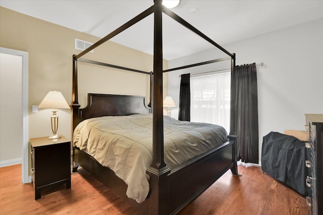 6510 S Woodlawn Ave Unit 1, Chicago, IL 60637 - bedroom featuring visible vents, baseboards, and wood finished floors