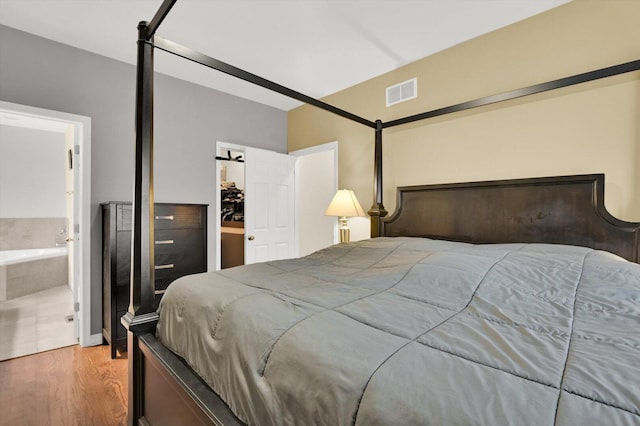 6510 S Woodlawn Ave Unit 1, Chicago, IL 60637 - bedroom with visible vents, wood finished floors, and ensuite bath