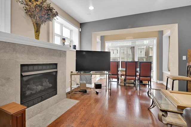 6510 S Woodlawn Ave Unit 1, Chicago, IL 60637 - living area featuring baseboards, a tiled fireplace, wood finished floors, and recessed lighting