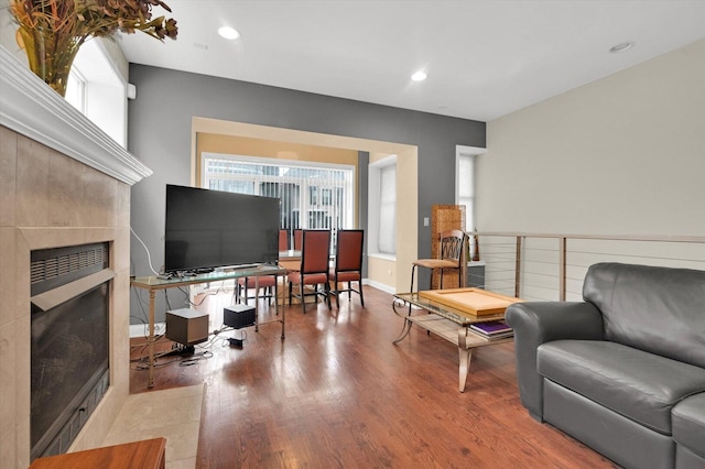 6510 S Woodlawn Ave Unit 1, Chicago, IL 60637 - living area featuring baseboards, a tiled fireplace, wood finished floors, and recessed lighting