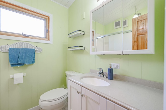 full bath with a shower with shower door, visible vents, toilet, and vanity