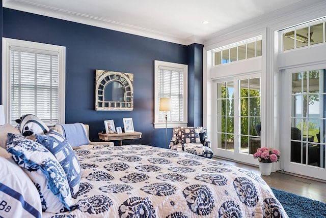 bedroom featuring access to exterior, crown molding, wood finished floors, and recessed lighting