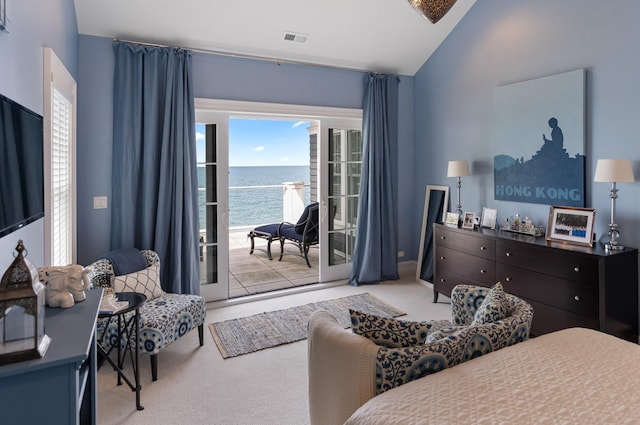 bedroom with access to exterior, light carpet, a water view, and vaulted ceiling