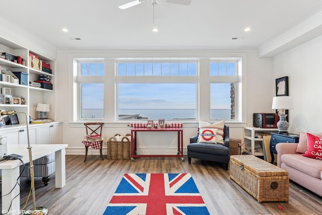 rec room featuring ornamental molding, light wood finished floors, and ceiling fan
