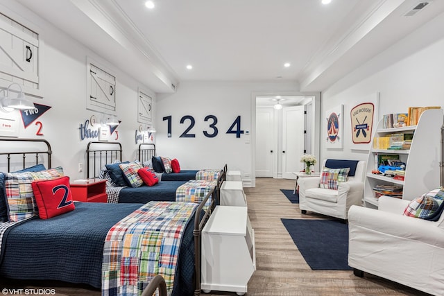 living area featuring wood finished floors, ornamental molding, and recessed lighting