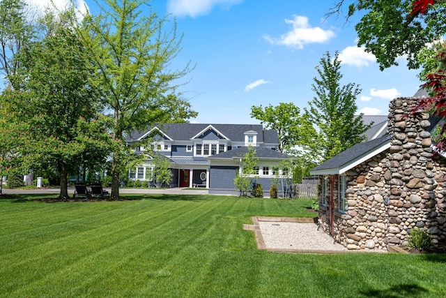 rear view of house featuring a lawn