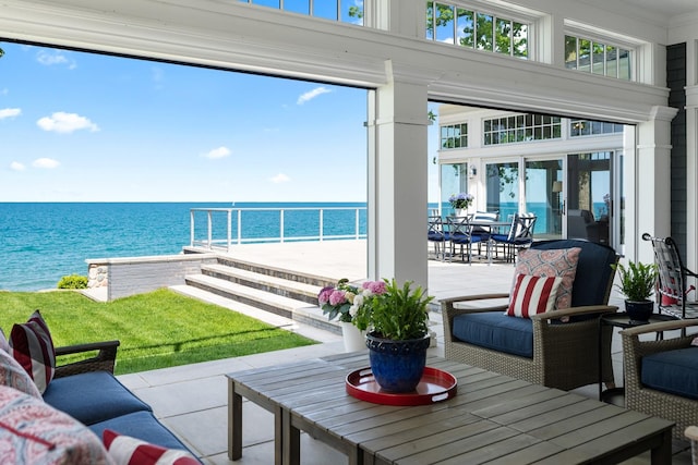 sunroom / solarium featuring a water view and healthy amount of natural light
