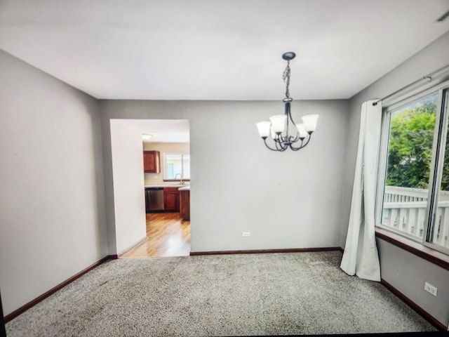 1208 Fox Hill Ln, North Aurora, IL 60542 - spare room featuring baseboards, a notable chandelier, and light carpet