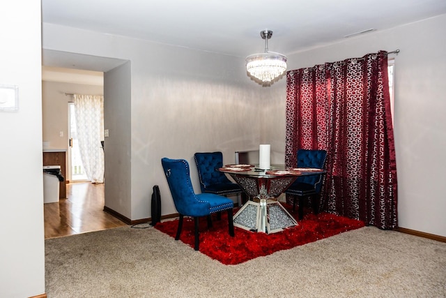 1208 Fox Hill Ln, North Aurora, IL 60542 - carpeted dining space featuring visible vents, baseboards, and an inviting chandelier