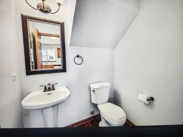 1208 Fox Hill Ln, North Aurora, IL 60542 - bathroom featuring toilet, lofted ceiling, wood finished floors, and baseboards
