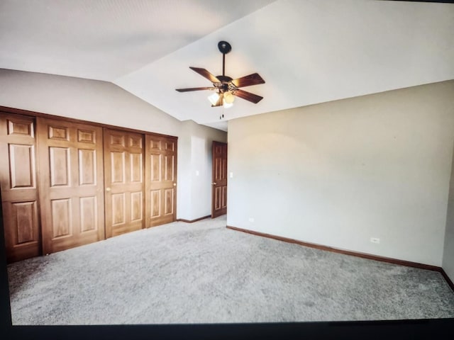 1208 Fox Hill Ln, North Aurora, IL 60542 - unfurnished bedroom featuring a closet, baseboards, lofted ceiling, and carpet floors