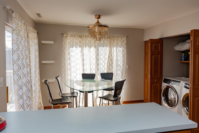 1208 Fox Hill Ln, North Aurora, IL 60542 - dining space featuring an inviting chandelier, separate washer and dryer, and visible vents