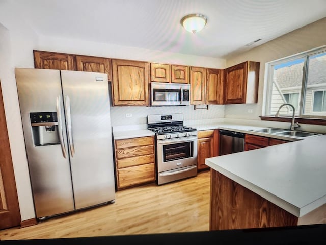 1208 Fox Hill Ln, North Aurora, IL 60542 - kitchen with light wood-type flooring, a sink, visible vents, and stainless steel appliances