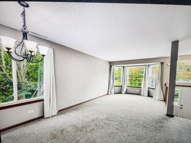 1208 Fox Hill Ln, North Aurora, IL 60542 - unfurnished living room with carpet floors, baseboards, and a notable chandelier