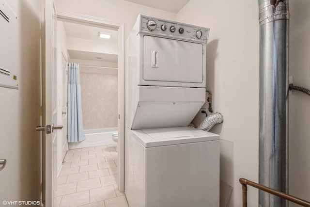 3630 N Harlem Ave Unit 410, Chicago, IL 60634 - washroom with stacked washing machine and dryer and light tile patterned floors